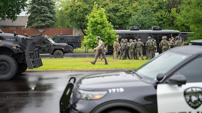 Law enforcement officers including local police, sheriffs and the FBI, stage less than a mile from a shooting in Brooklyn Park, Minn. on Saturday, June 14, 2025.