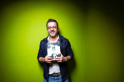 Palestinian cartoonist Mohammad Sabaaneh, with his book of illustrations, on Monday at Casa Árabe, in Madrid.